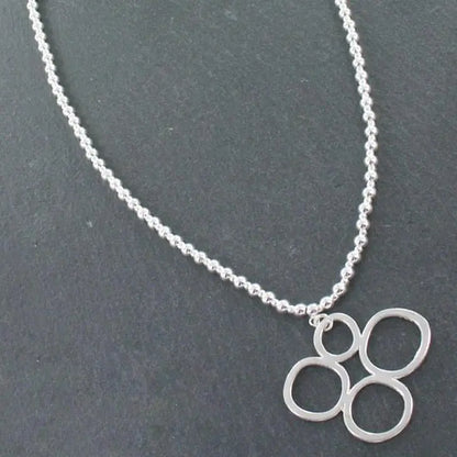 Silver bubble pendant necklace on a silver ball chain, featuring a shiny, round silver pendant from Suzie Blue Canada.