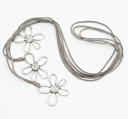 Silver flower necklace with three detailed flower charms on suede cord, by Suzie Blue Canada.