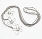 Silver flower necklace with three detailed flower charms on suede cord, by Suzie Blue Canada.