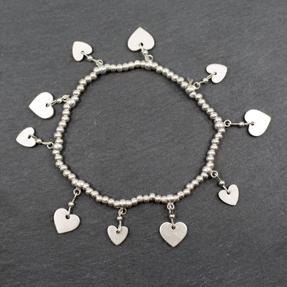Silver heart charm bracelet with elasticated design, featuring a delicate chain and heart pendant, by Suzie Blue Canada.
