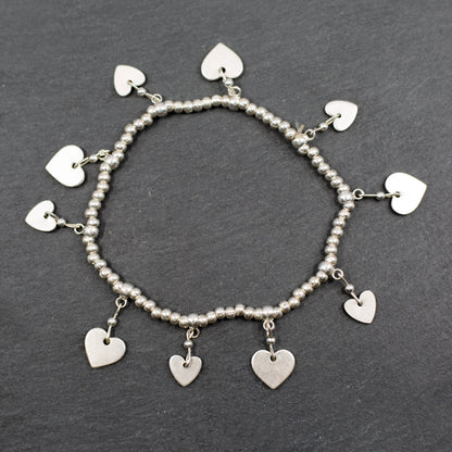 Silver heart charm bracelet with elasticated design, featuring a delicate chain and heart pendant, by Suzie Blue Canada.