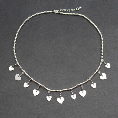 Silver plate charm necklace with drop heart pendants, elegant short design by Suzie Blue Canada.