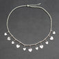 Silver plate charm necklace with drop heart pendants, elegant short design by Suzie Blue Canada.
