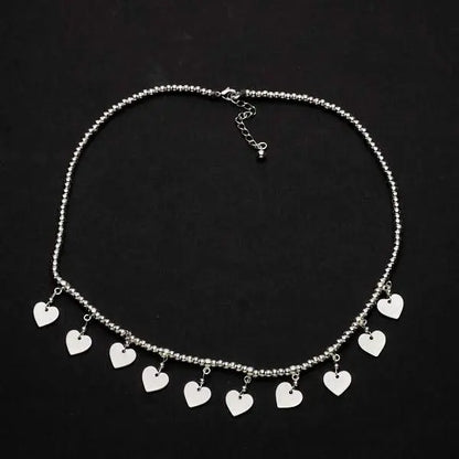 Silver plate charm necklace by Suzie Blue Canada featuring drop heart pendants in an elegant short design.
