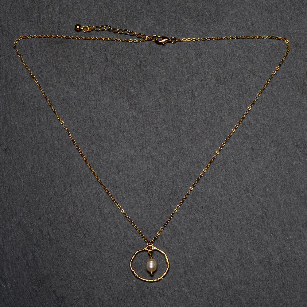 Simple gold pearl necklace with ring detail, elegant jewelry piece by Suzie Blue Canada, featuring small pearls and a delicate gold chain.