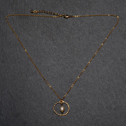 Simple gold pearl necklace with ring detail, elegant jewelry piece by Suzie Blue Canada, featuring small pearls and a delicate gold chain.