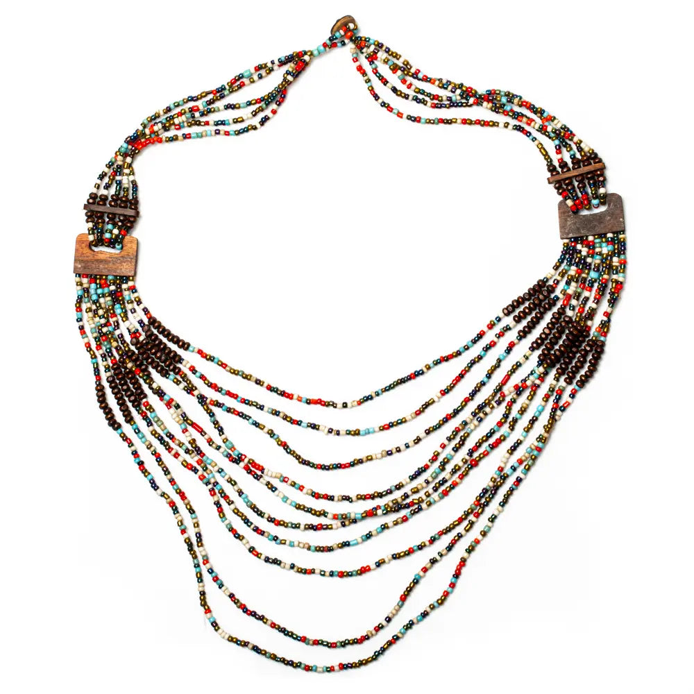 Long multi-strand necklace with wood accents by Suzie Blue Canada, featuring layered strands and natural wooden details.