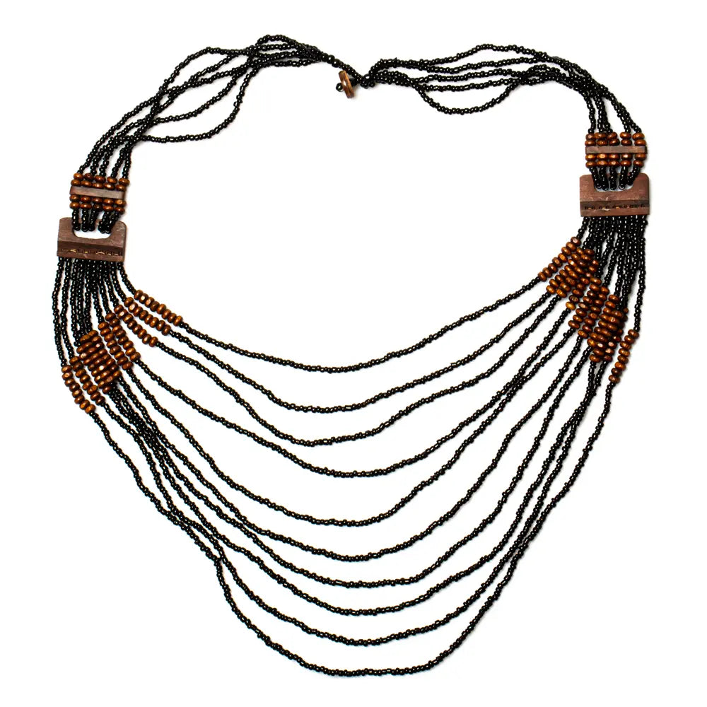 Long multi-strand necklace by Suzie Blue Canada featuring wood detail and layered design, perfect for boho or casual styles.