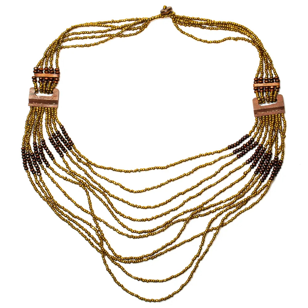 Long multi-strand necklace with wood detail by Suzie Blue Canada, featuring layered chains and natural wood accents.