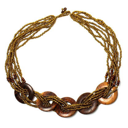 Multi-strand wooden ring necklace by Suzie Blue Canada featuring layered wooden rings on a delicate chain.