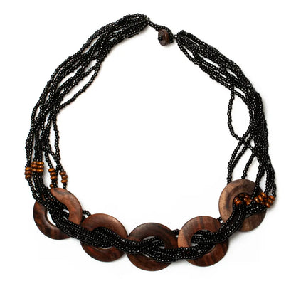 Multi-strand wooden ring necklace by Suzie Blue Canada featuring layered wooden rings on a delicate chain.