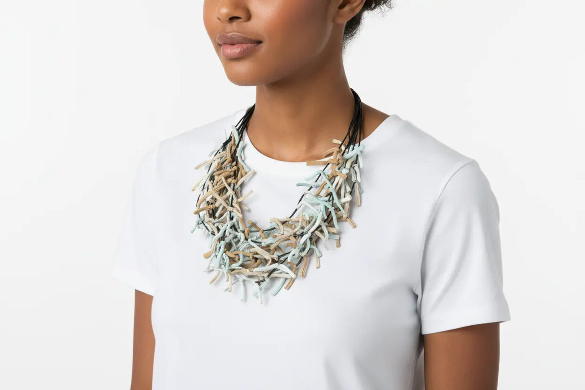 Multi-strand fabric necklace by Suzie Blue Canada with colorful woven fabric strands and adjustable clasp.