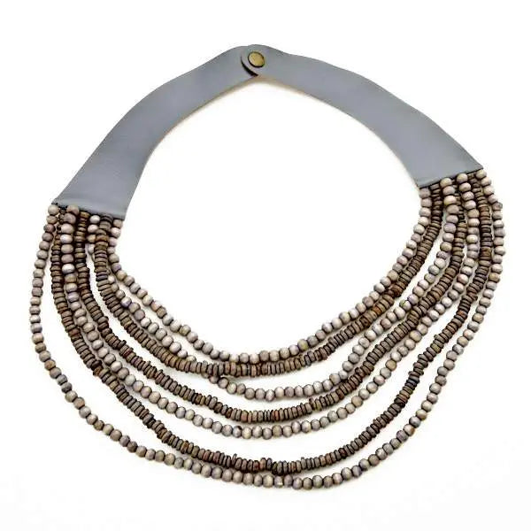 Multi-strand wooden bead necklace by Suzie Blue Canada featuring natural wooden beads and layered design.