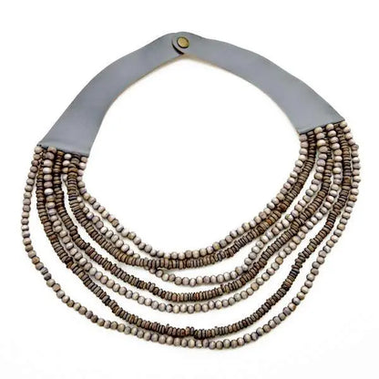 Multi-strand wooden bead necklace by Suzie Blue Canada featuring natural wooden beads and layered design.