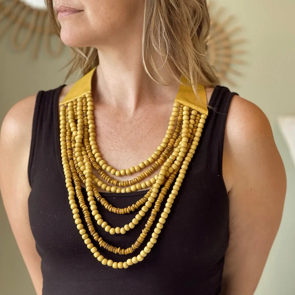 Multi strand wooden bead necklace by Suzie Blue Canada featuring various natural wooden beads and a stylish layered design.