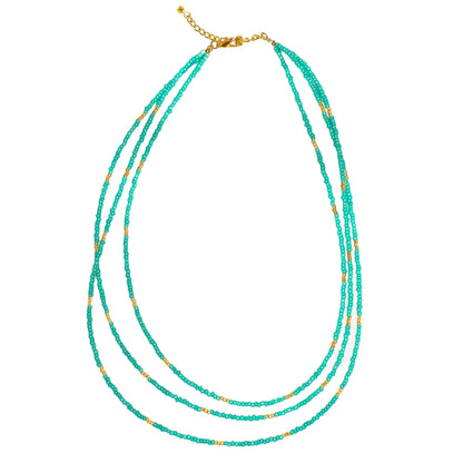 Triple strand seed bead necklace with gold accents by Suzie Blue Canada, featuring colorful seed beads and elegant gold details.