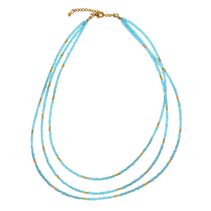 Triple strand seed bead necklace with gold accents by Suzie Blue Canada, featuring colorful seed beads and elegant gold details.