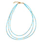 Triple strand seed bead necklace with gold accents by Suzie Blue Canada, featuring colorful seed beads and elegant gold details.