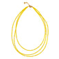 Triple strand seed bead necklace with gold accents by Suzie Blue Canada, featuring colorful beads and elegant design.