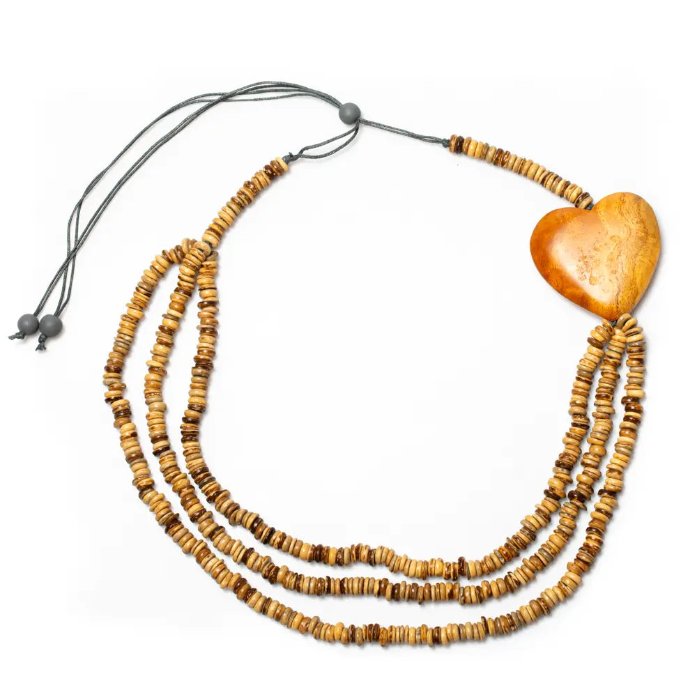 Triple strand coconut bead necklace with wooden heart accent by Suzie Blue Canada, featuring natural coconut beads and a wooden heart charm.