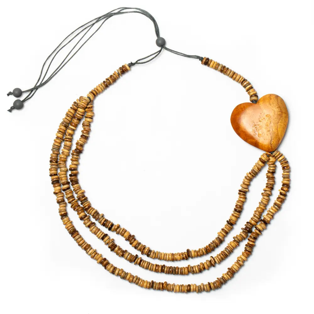 Triple strand coconut bead necklace with wooden heart accent, stylish jewelry piece by Suzie Blue Canada.