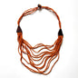 Multi-strand wooden necklace with unique details, crafted by Suzie Blue Canada, featuring natural wood beads and intricate design.