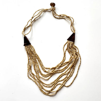 Multi-strand wooden necklace with unique details by Suzie Blue Canada, featuring natural wood beads and intricate design.