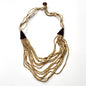 Multi-strand wooden necklace with unique details by Suzie Blue Canada, featuring natural wood beads and intricate design.
