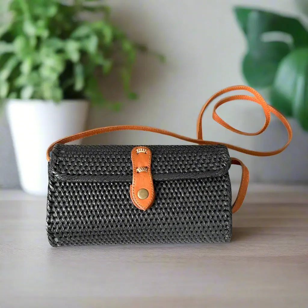 Black rattan purse by Suzie Blue Canada, featuring a stylish woven design and compact shape perfect for everyday accessories.