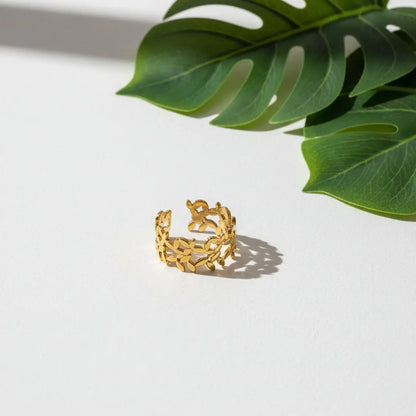 Elegant gold plated multi petal ring by Suzie Blue Canada displayed on a finger in a lifestyle setting.