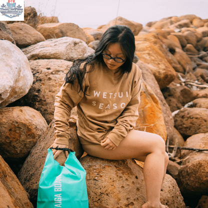 20L Taiga Board dry bag with adjustable carbon paddle, ideal for water sports and outdoor adventures.
