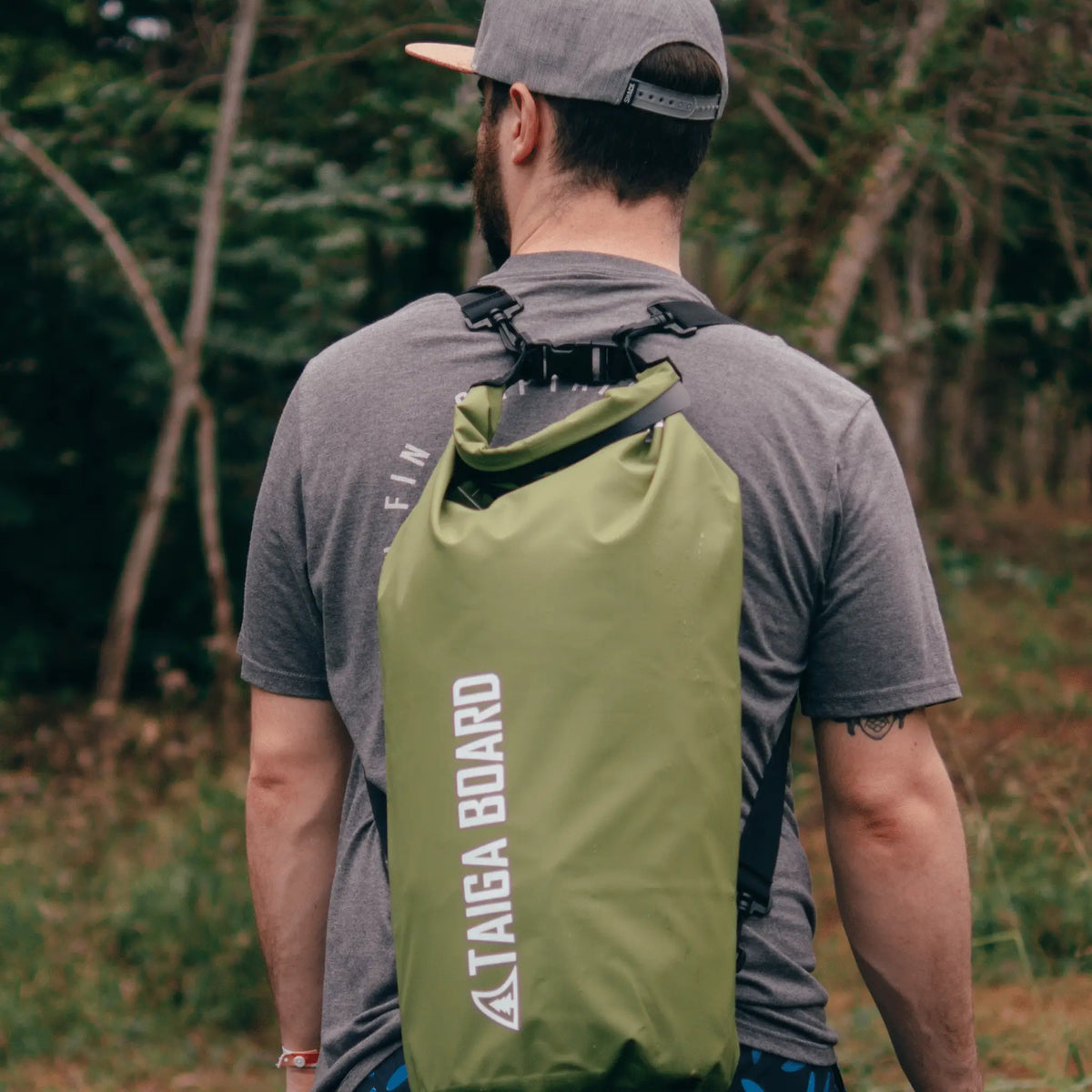 20L Taiga Board dry bag with adjustable carbon paddle, ideal for water sports and outdoor adventures.