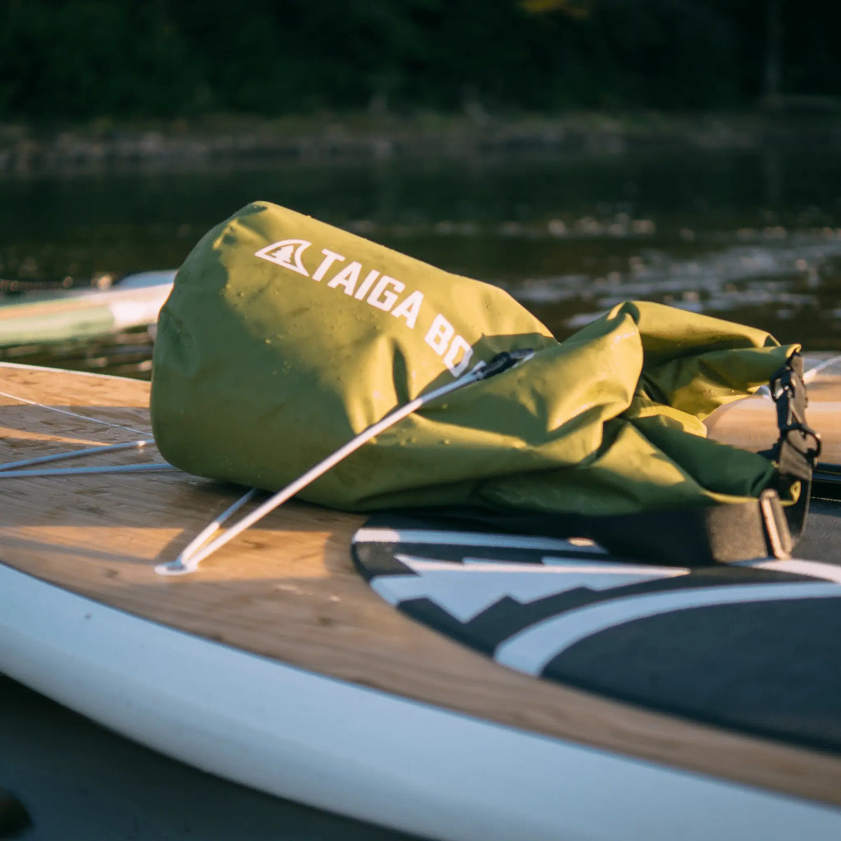 20L Taiga Board dry bag with adjustable carbon paddle, perfect for water sports and outdoor adventures.