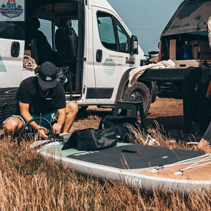 Taiga Board premium electric pump for inflatable paddle boards, showing battery operation and digital pressure display.