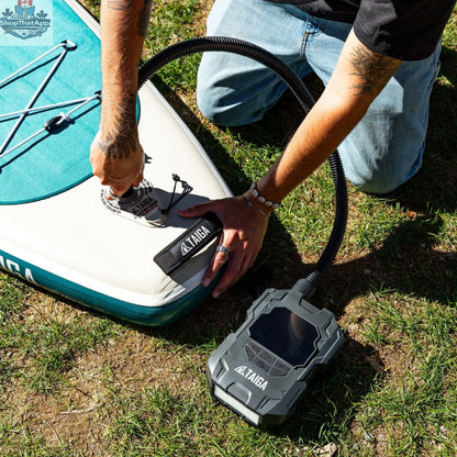 Taiga Board electric pump for paddle boards inflates up to 22 PSI, battery-operated, compact accessory for easy inflating.