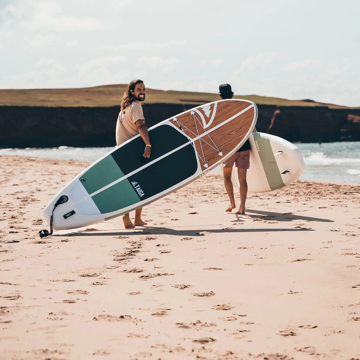 Taiga Board Nano Zip Air 9'8" inflatable paddle board on water with a paddle, compact design ideal for paddling adventures.
