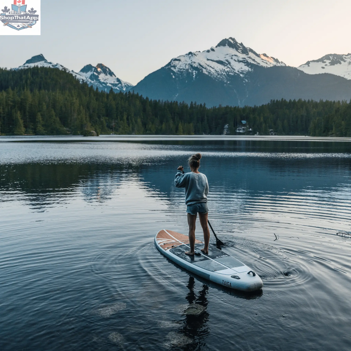 Taiga Board Nano Zip Air 9'8" inflatable SUP paddleboard on water with a sleek, compact design and bright color scheme.