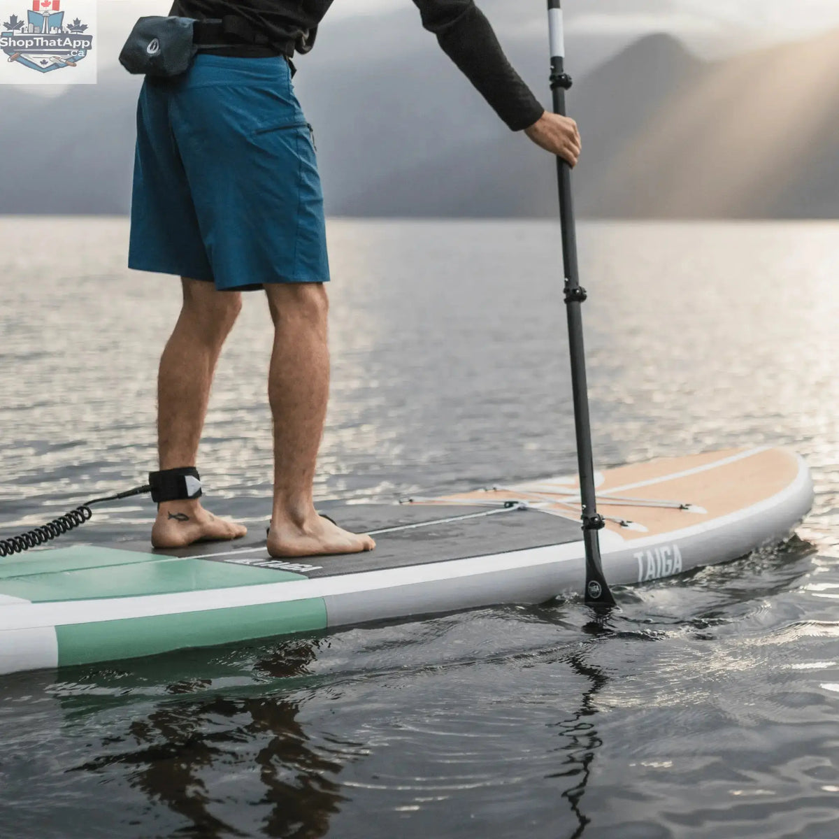 Taiga Board Nano ZIP Air 9'8" compact inflatable SUP paddle board on water, showcasing its sleek design and portability.