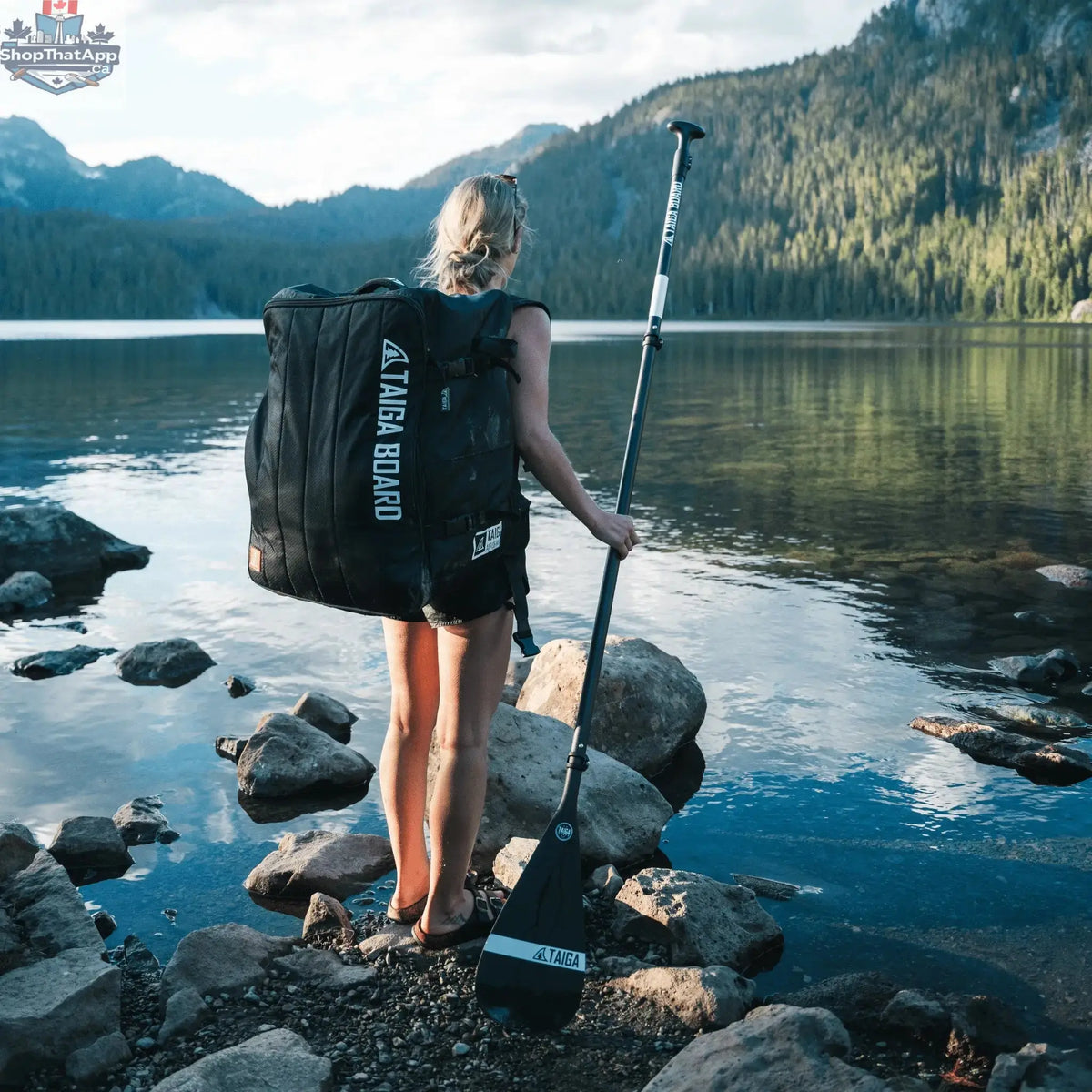Taiga Board Nano Zip Air 9'8" compact inflatable SUP paddle board on water, featuring a sleek design and durable construction.