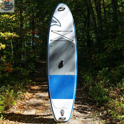 Taiga Board UKEE 10'8'' inflatable paddleboard in the value kit, shown with pump, leash, and accessories on a stand-up paddleboard.