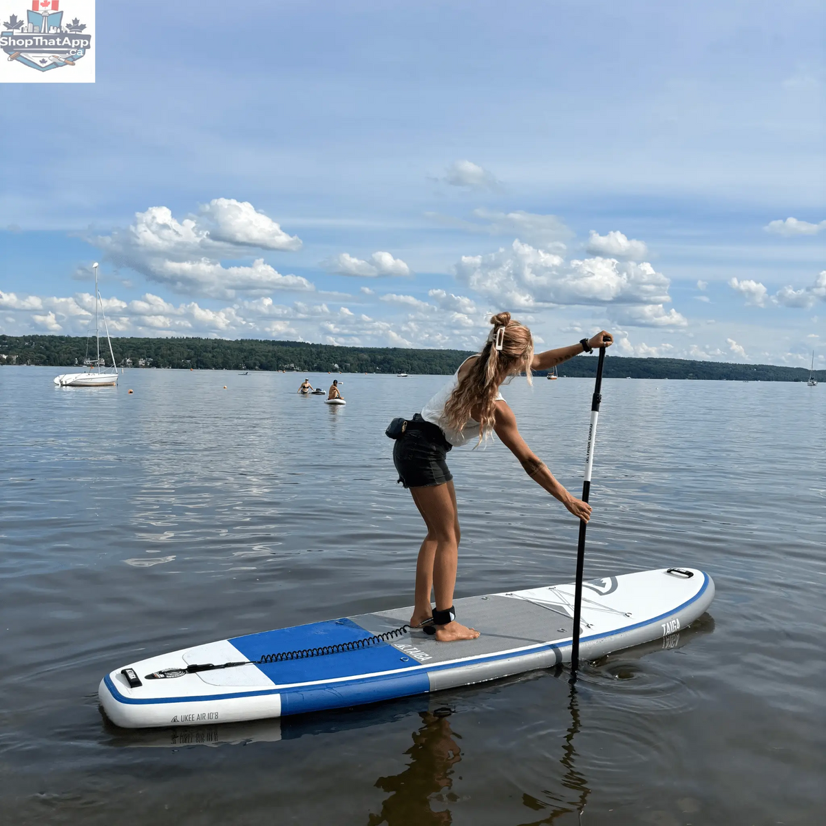 Taiga Board UKEE 10'8" inflatable paddle board in the value kit, shown fully inflated on water with paddle and accessories.