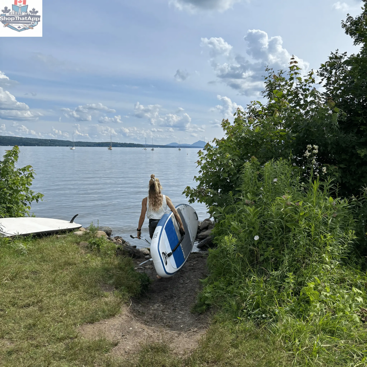 Taiga Board UKEE 10'8'' inflatable paddle board with value kit, shown on water with paddle and accessories included.