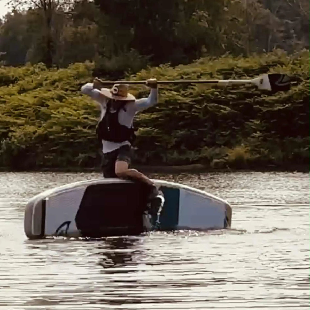 Taiga Board Freestyle 9'10'' inflatable stand-up paddleboard on water, showcasing its sleek design and durable construction.