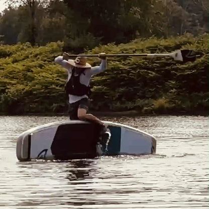 Taiga Board Freestyle 9'10'' inflatable stand-up paddleboard on water, showcasing its sleek design and durable construction.