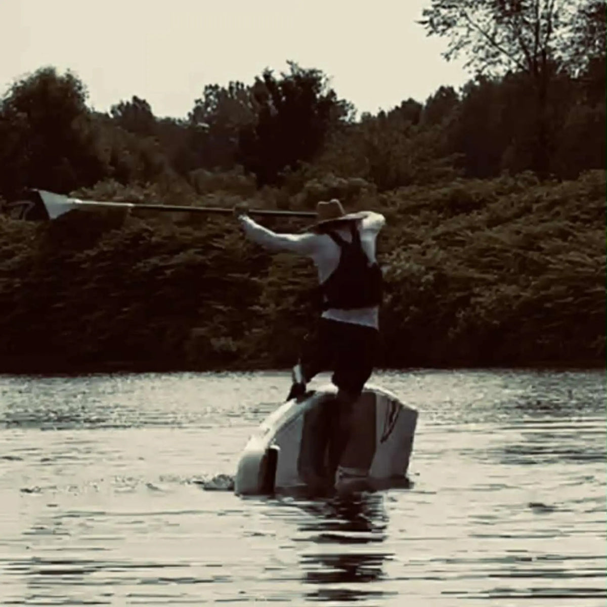 Taiga Board Freestyle 9'10" inflatable SUP paddle board on water, showcasing its sleek design and sturdy construction.