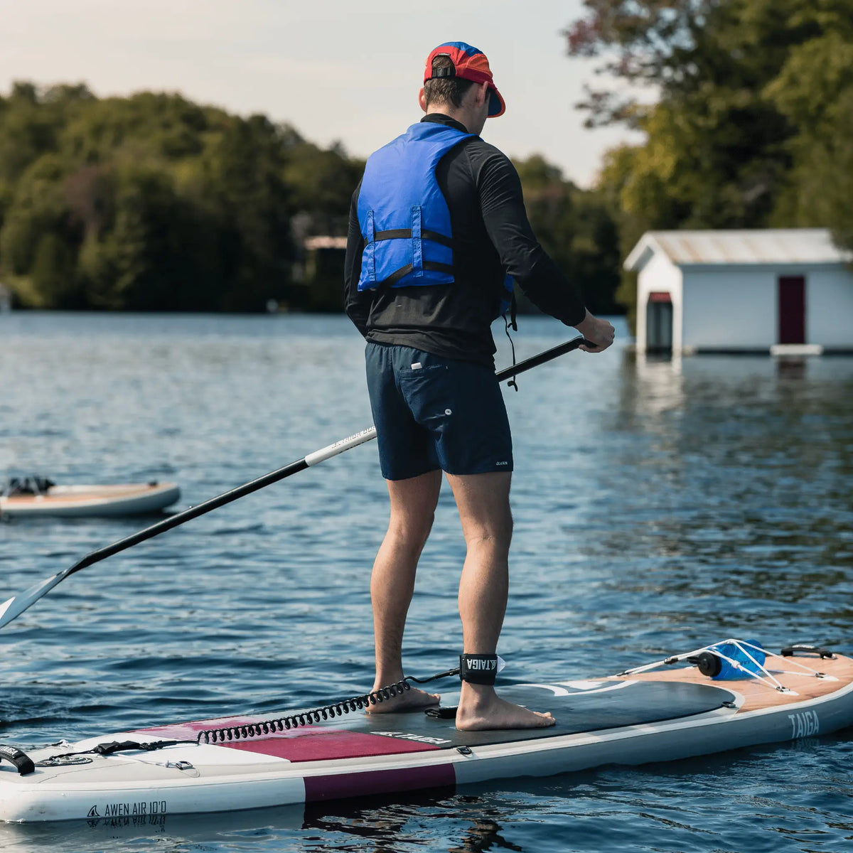 Taiga Board AWEN Inflatable 10-foot SUP paddle board on water, showcasing its sturdy design for water adventures.