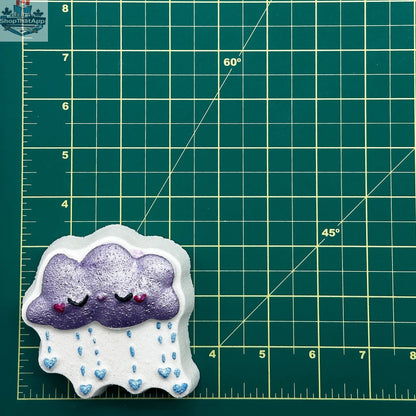 Whimsical raincloud-shaped bath and body decor by The Bomb Bar Canada, featuring a playful face design.