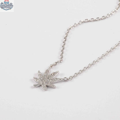 Silver cannabis leaf necklace featuring a detailed cannabis leaf pendant, stylish jewelry piece by The Kush Girls.