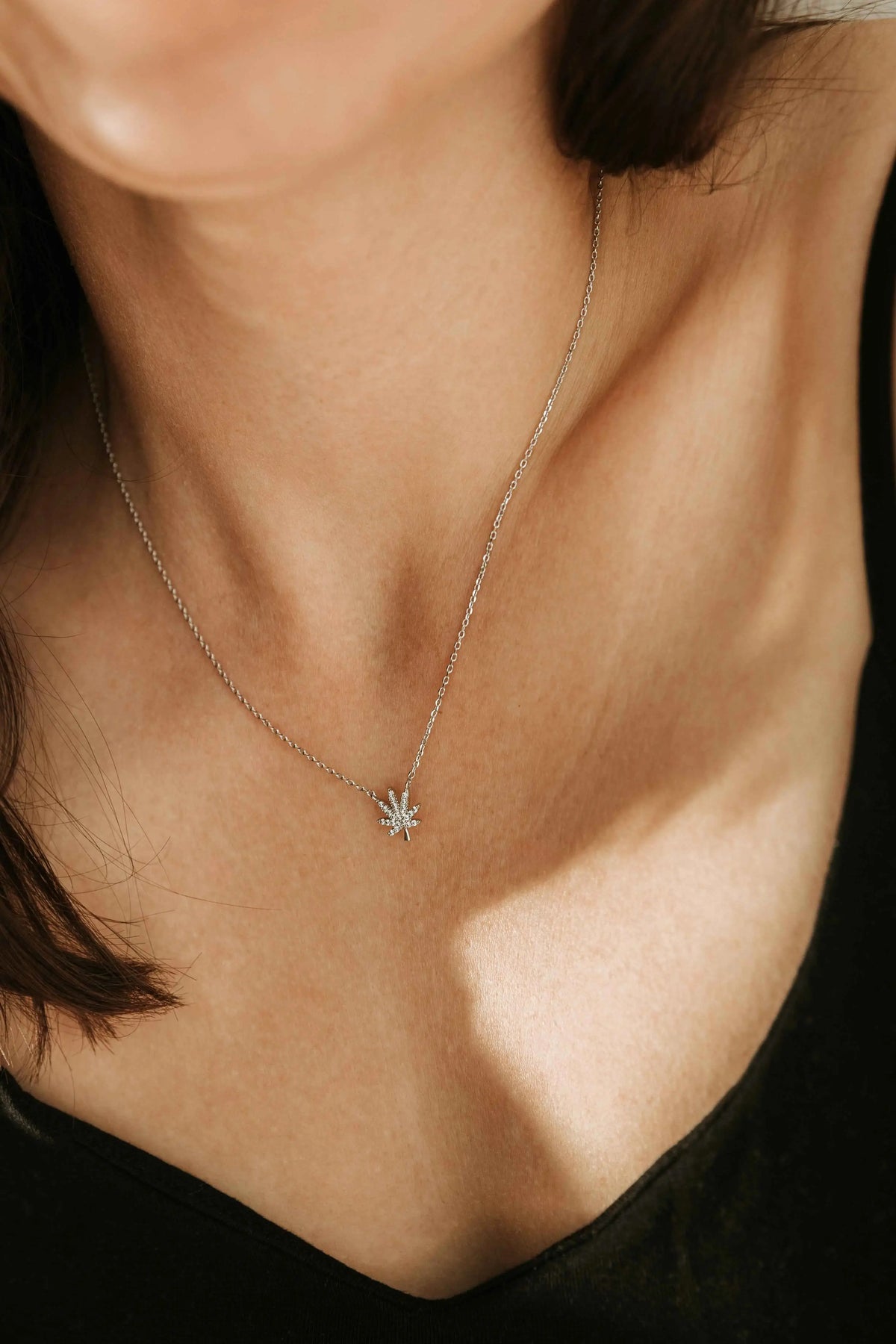 Silver cannabis leaf necklace featuring a detailed leaf pendant, crafted by The Kush Girls for a stylish, natural look.
