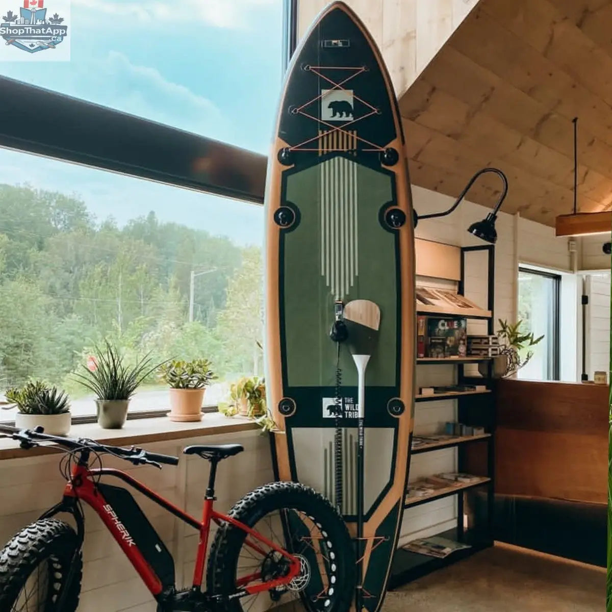Green Sequoia 11' inflatable paddleboard canoe by The Wild Tribe, shown floating on water with a stable, premium design.